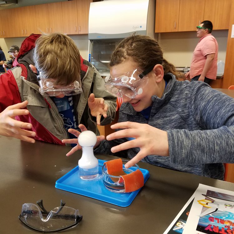 Young students work together on a science project in a lab