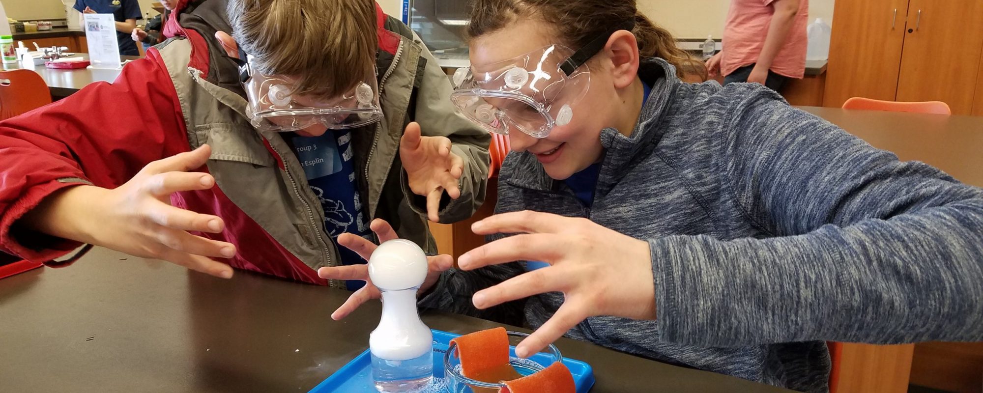 Young students work together on a science project in a lab